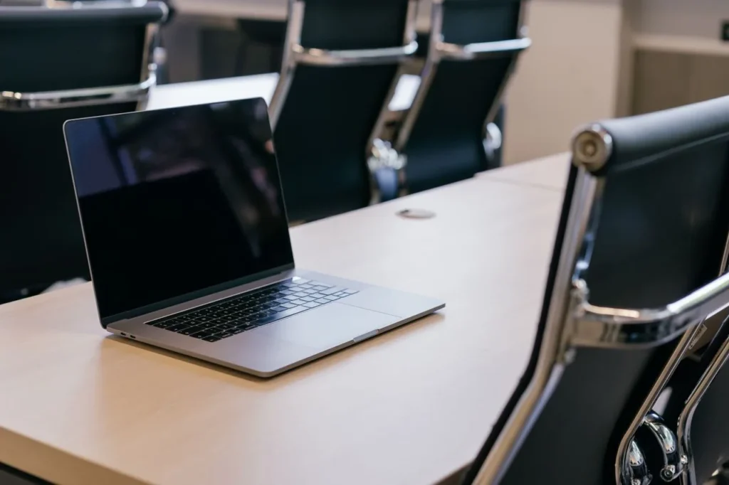 Laptop on a boardroom desk, ready for a client website project